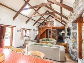 A living room with a staircase and sofa at Ty Felin Newport