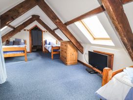 A bedroom with two beds and a dresser at Ty Felin in Newport