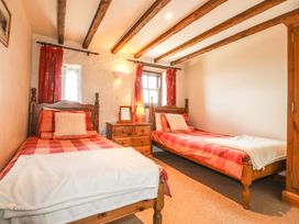 A bedroom with two beds and a window at Ty Felin Newport