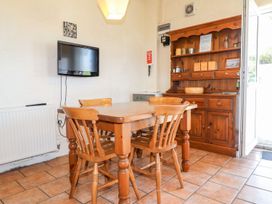 A dining room with a table and chairs at Ty Cariad in Newport