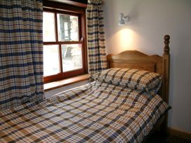 A bedroom with a bed and window at Ty Cariad Newport