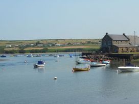 A marina with boats and a building at Ty Cariad in Newport