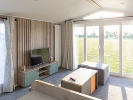 A living room with a television and coffee table at Morwenna in Hayle