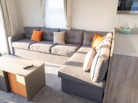 A living room with a sofa and coffee table at Morwenna in Hayle