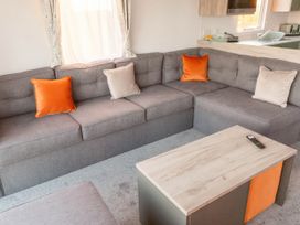 A living room with a sofa and coffee table at Morwenna in Hayle