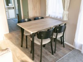 A dining room with a table and chairs at Morwenna in Hayle