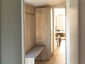 A hallway with a bench and hooks at Morwenna in Hayle