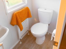 A bathroom with a toilet and sink at Morwenna in Hayle