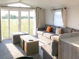 A living room with a sofa and coffee table at Lamorna in Hayle