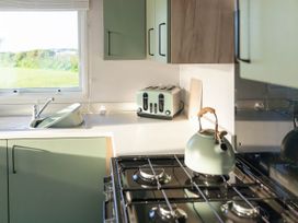 A kitchen with a toaster and kettle at Lamorna in Hayle