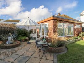 A garden with a patio area and seating at The Summerhouse in Llandudno