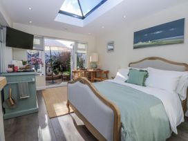A bedroom with a bed and television at The Summerhouse in Llandudno