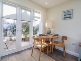 A dining area with a small table and chairs at The Summerhouse in Llandudno