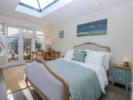 A bedroom with a bed and table at The Summerhouse in Llandudno