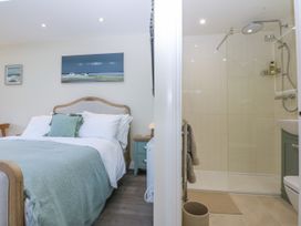 A bedroom with an ensuite shower area at The Summerhouse in Llandudno