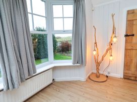 A snug with a window and wooden door at Braeburn in Bamburgh