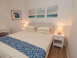 A bedroom with a bed and bedside tables at Braeburn in Bamburgh
