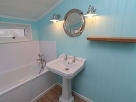 A bathroom with bathtub and sink at Braeburn in Bamburgh