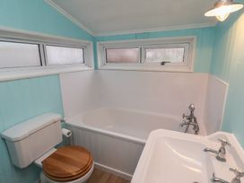 A bathroom with bathtub and washbasin at Braeburn in Bamburgh