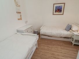 A bedroom with two beds and a nightstand at Braeburn in Bamburgh