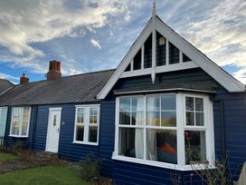 A house exterior with windows and a garden at Braeburn in Bamburgh