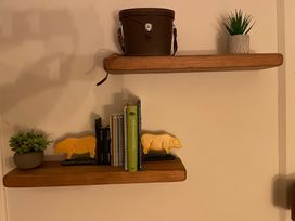 Shelves with books and decor items at Braeburn in Bamburgh