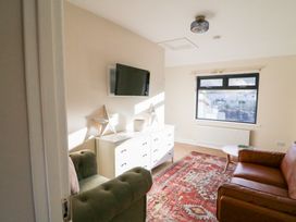 A living room with a sofa and television at Duck Cottage