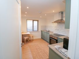A kitchen with table and chairs at Duck Cottage 