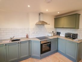 A kitchen with sink stove oven microwave toaster and kettle at Duck Cottage