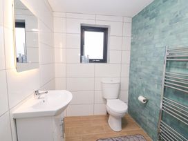 A bathroom with a sink, toilet, and towel rack at Duck Cottage