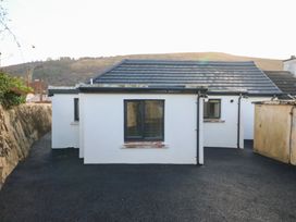 A building with windows and a roof at Duck Cottage