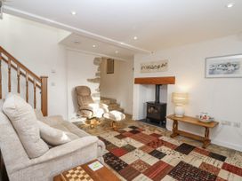 A living room with a sofa and fireplace at Swallow Cottage Bullhornstone near South Brent