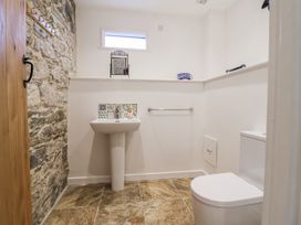 A bathroom with a toilet and sink at Swallow Cottage Bullhornstone near South Brent