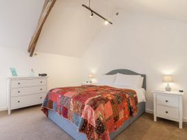 A bedroom with a bed and nightstands at Swallow Cottage Bullhornstone near South Brent