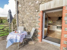 An outdoor patio with table set for tea at Swallow Cottage Bullhornstone near South Brent