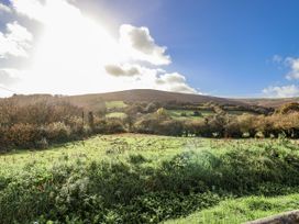 A view of hills and trees at Swallow Cottage Bullhornstone near South Brent
