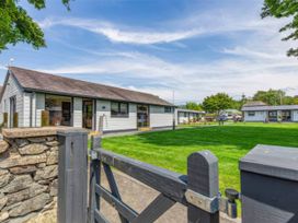 A house with a gate and lawn area at Aspen Apartment in Llanrwst