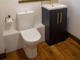 A bathroom with a toilet and a sink at Aspen Apartment in Llanrwst