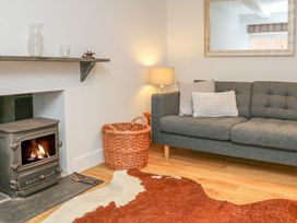 A living room with a sofa and a fireplace at The Old Workshop 