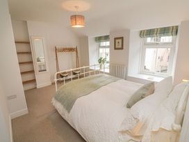 A bedroom with a bed and shelves at The Old Workshop in 