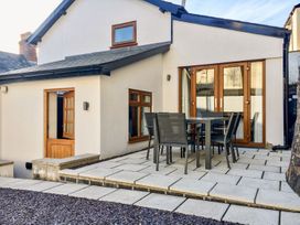 An outdoor area with a table and chairs at The Old Workshop in 