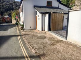 An outdoor view of a property with a wooden gate and gravel path at The Old Workshop in 