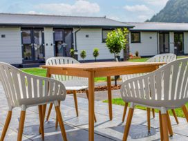 A table and chairs outside at White Willow Apartment Llanrwst