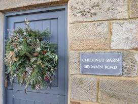 An entrance with a decorative wreath and a nameplate at Chestnut Barn Aislaby near Whitby