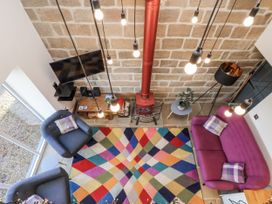 A living room with a colorful rug and seating area at Chestnut Barn Aislaby near Whitby