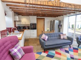 A kitchen with a sofa and armchair in Chestnut Barn Aislaby near Whitby