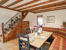 A dining room with a table set for meals at Chestnut Barn Aislaby near Whitby