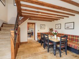 A dining room with a table and chairs at Chestnut Barn Aislaby near Whitby