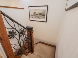 A staircase with decorative railings and framed artwork at Chestnut Barn in Aislaby near Whitby