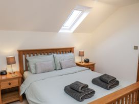 A bedroom with a bed and bedside tables at Chestnut Barn Aislaby near Whitby